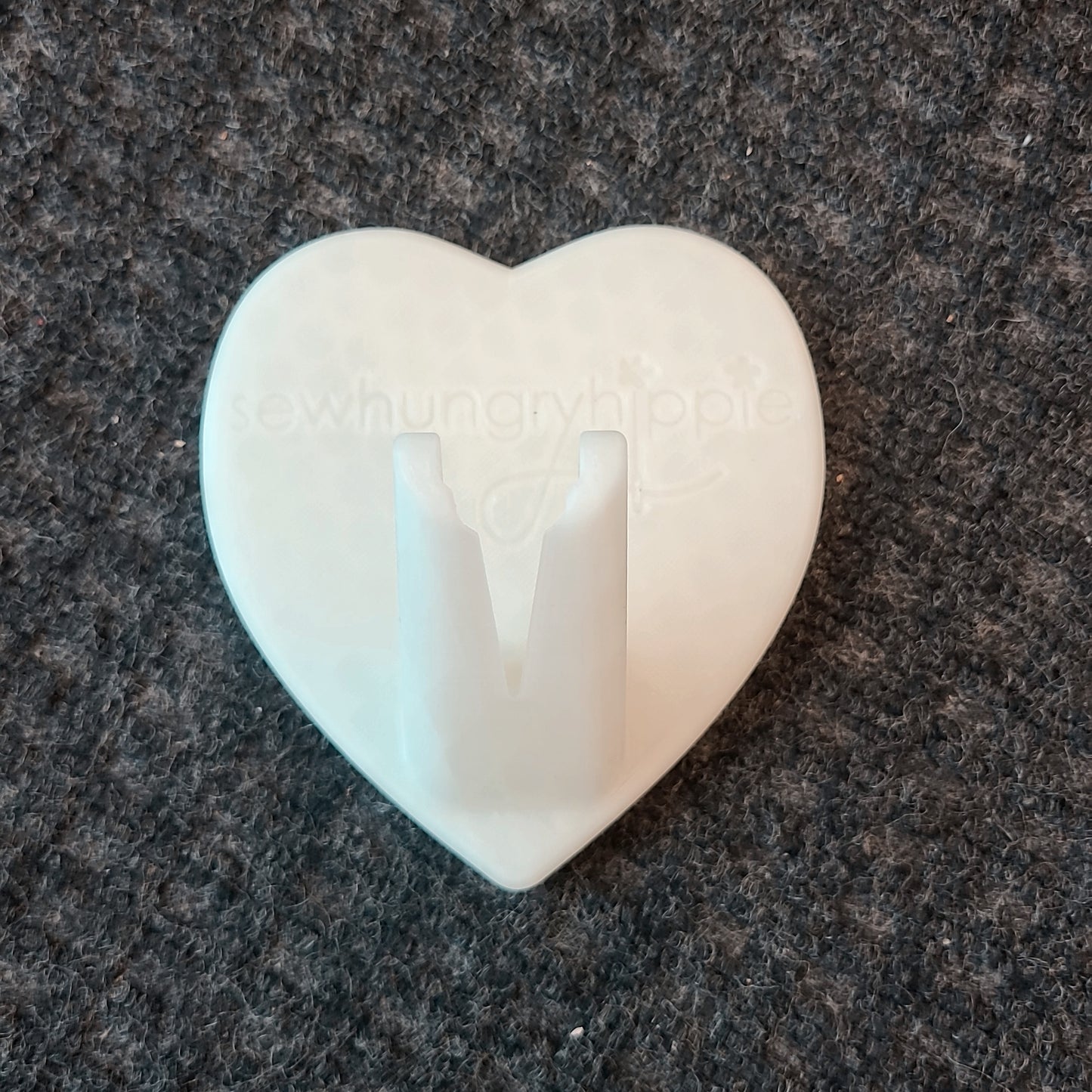 White heart-shaped wall hook.