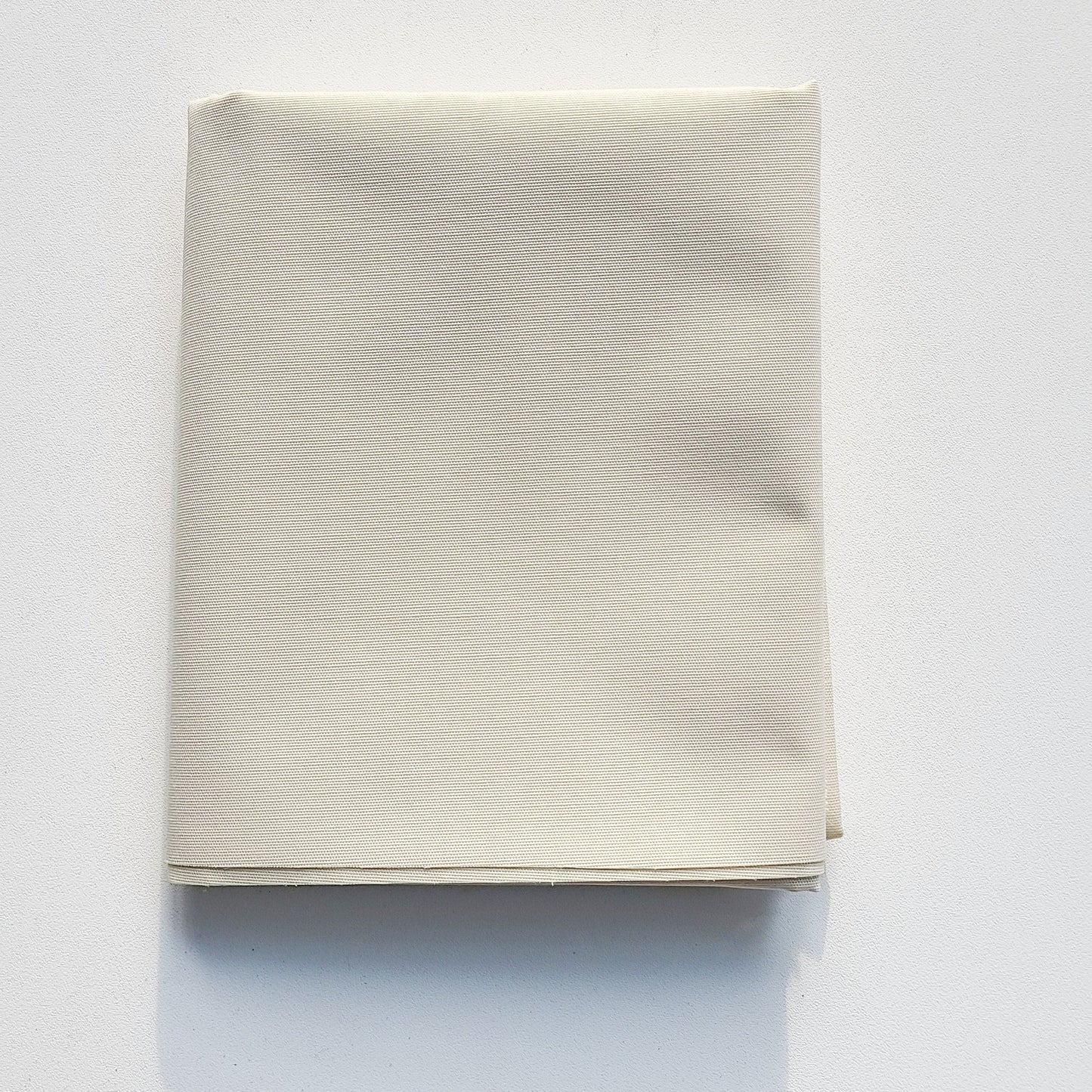 Folded cream-colored fabric.