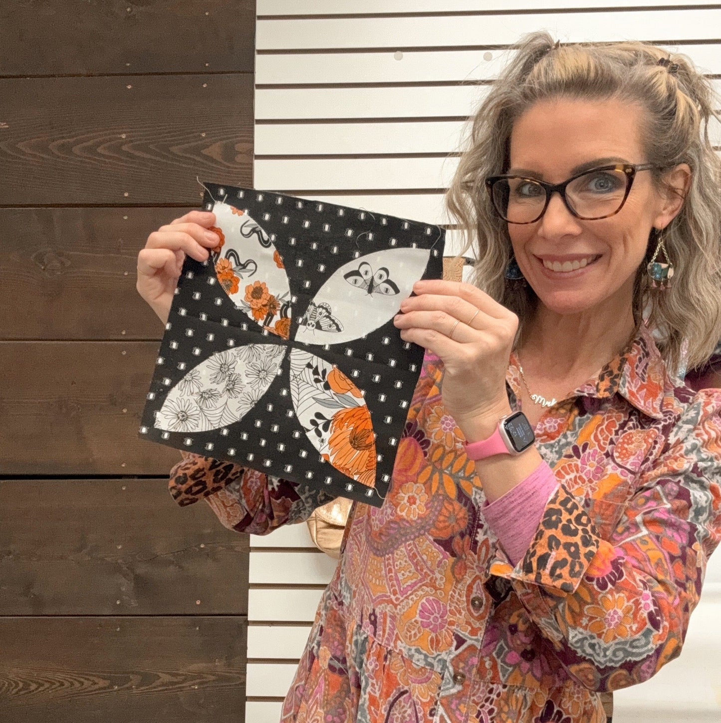 Woman holding a black polka dot quilt block (27E696C8-0F30)