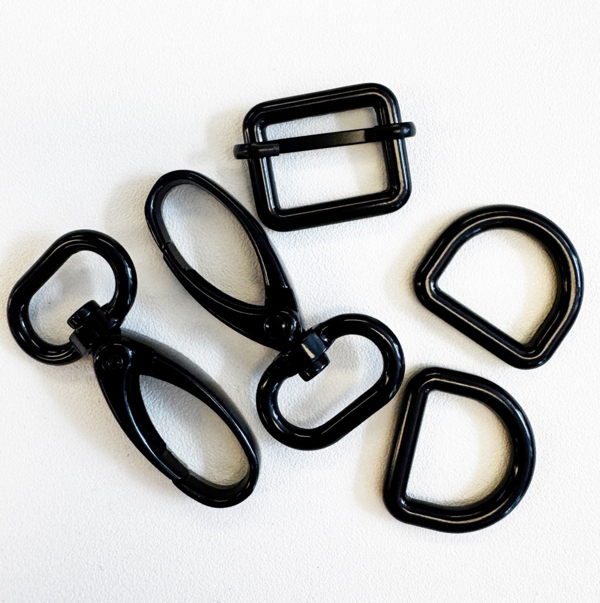 Set of black metal buckles on a white background