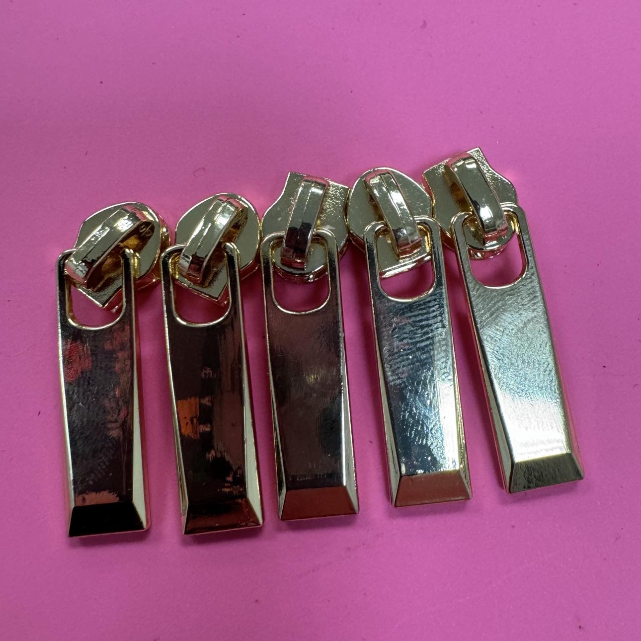 Five gold zipper pulls.