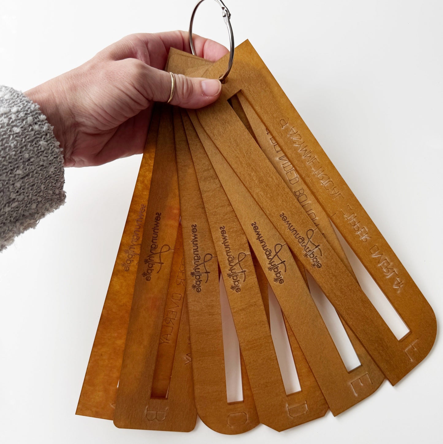 Hand holding a set of stencils, 515EC0FD-1C66-4822-A506-E14409D805C1.