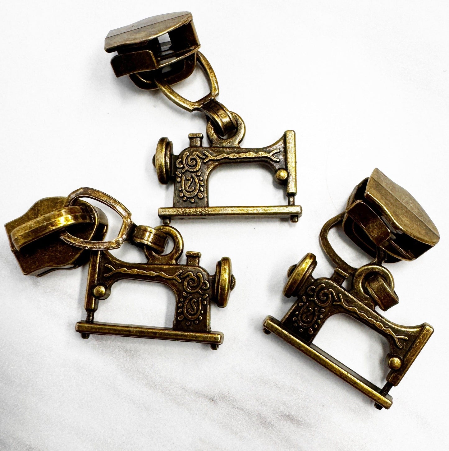 Sewing machine zipper pulls, antique brass finish