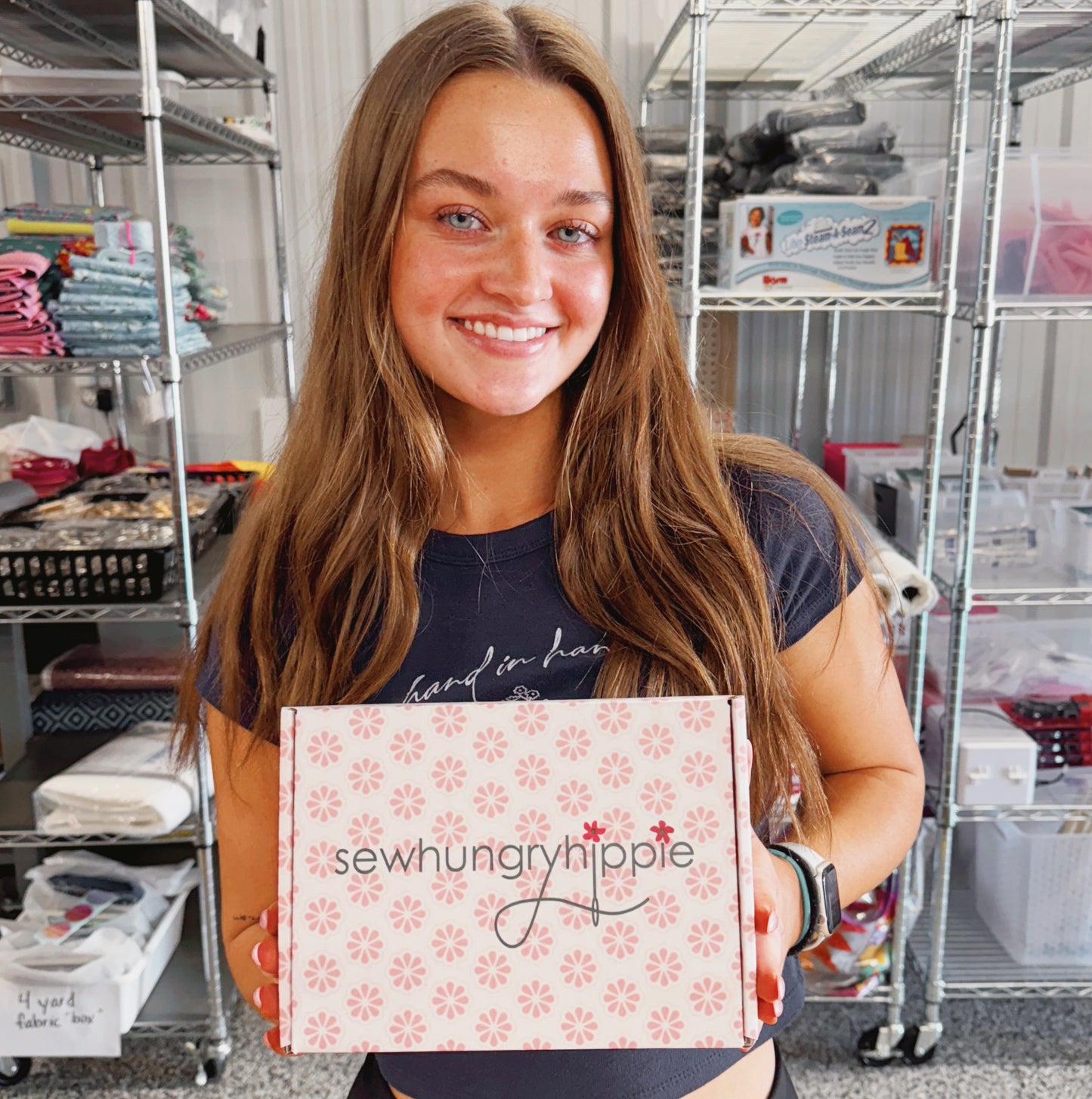 Sew Hungry Hippie owner holding box with products
