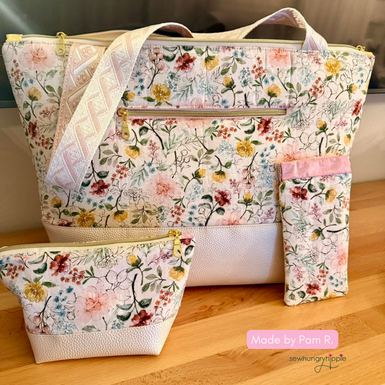 A handmade santorini bag set in floral quilting cotton and champagne moonglow vinyl