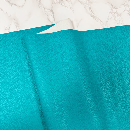 Turquoise leather texture on marble background