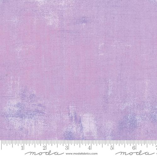 Freesia fabric with a textured, distressed purple pattern.