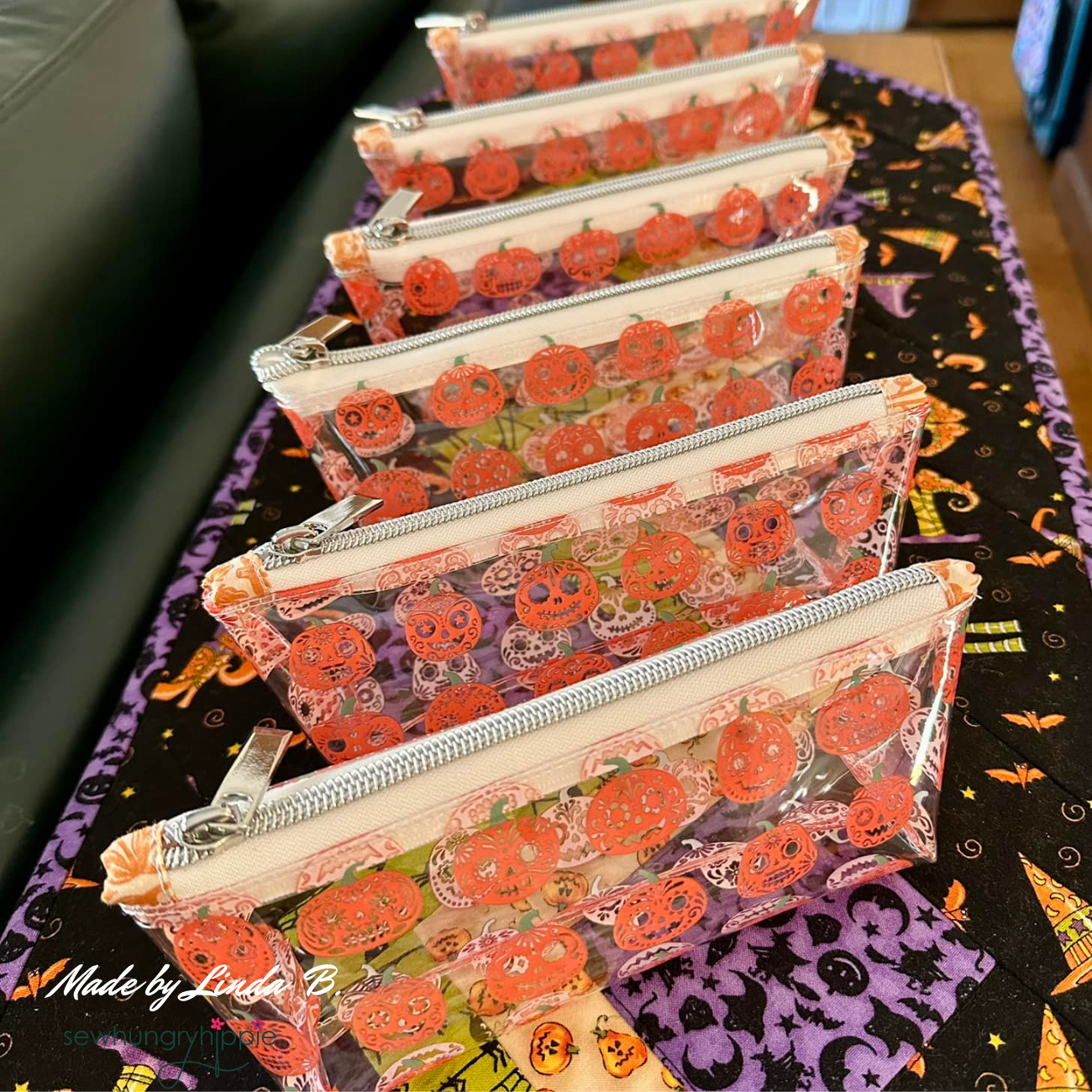 small pouches crafted from clear TPU vinyl with smiling jack o lantern design