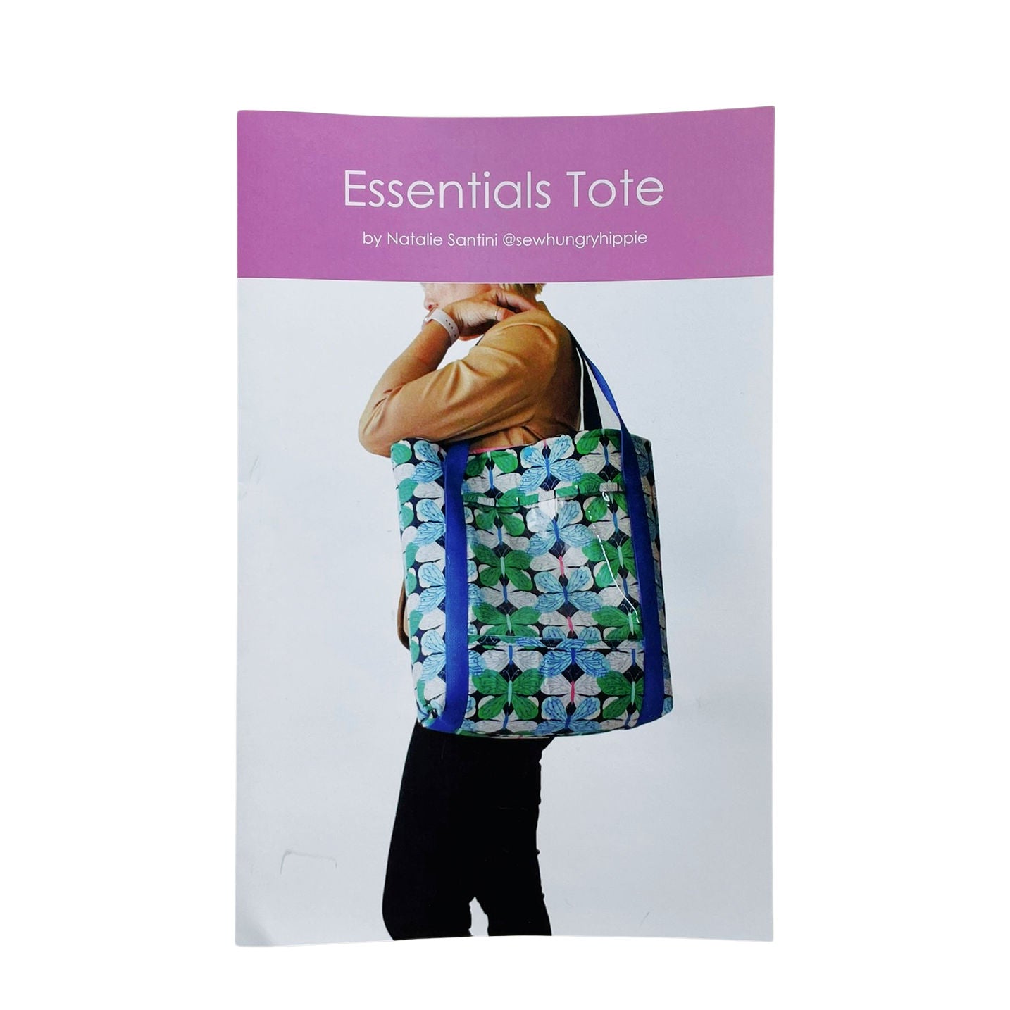 Person carrying a tote bag with floral pattern.