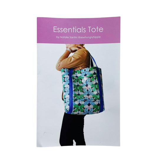 Person carrying a tote bag with floral pattern.