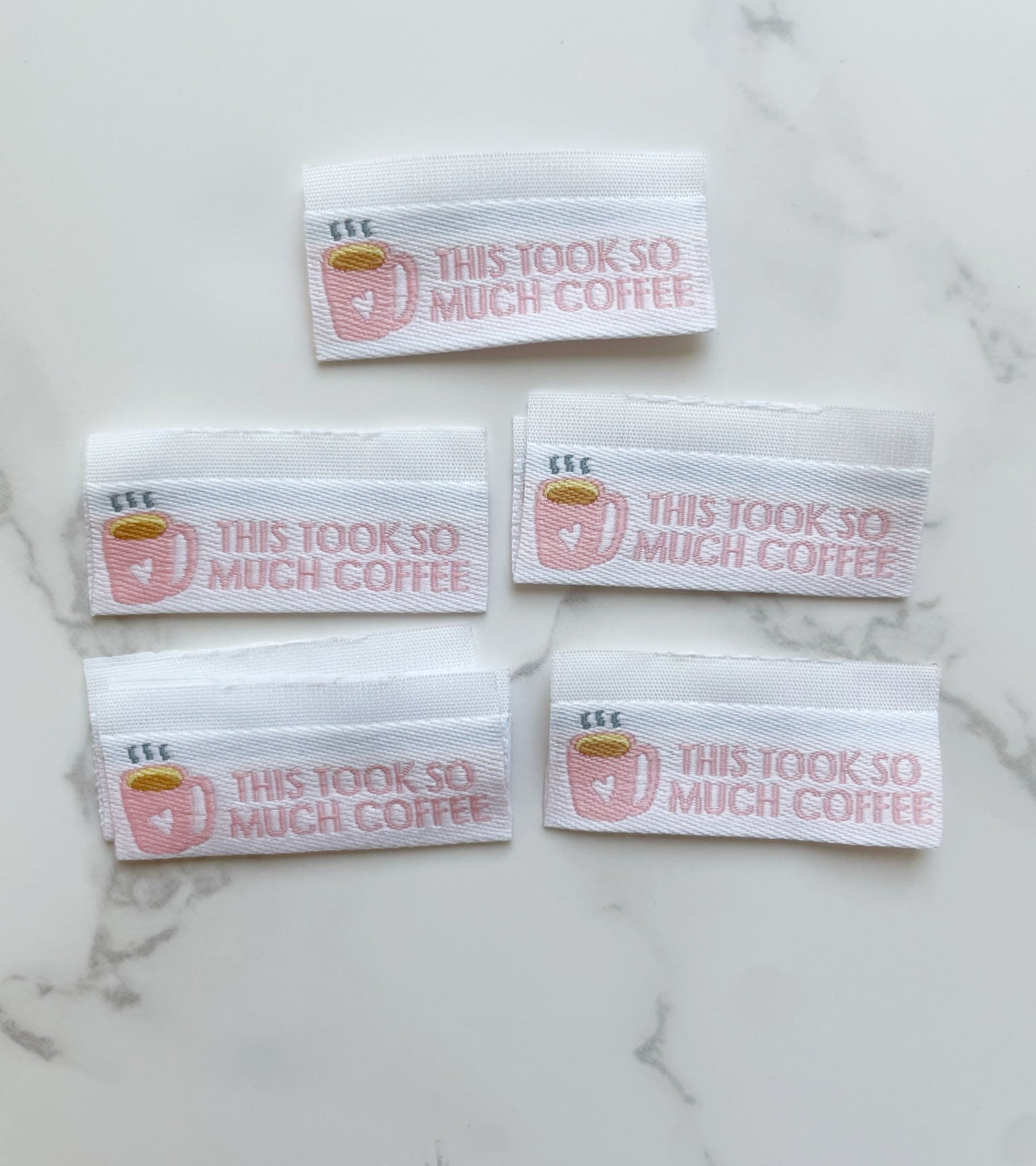 Five fabric labels with text This took so much coffee.