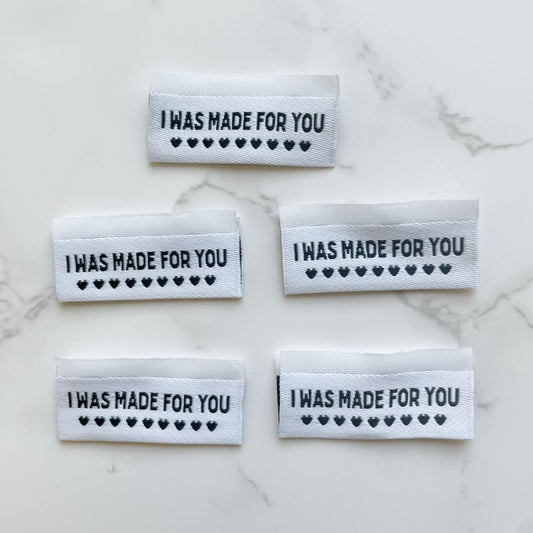 Five white labels with I WAS MADE FOR YOU text and heart symbols.