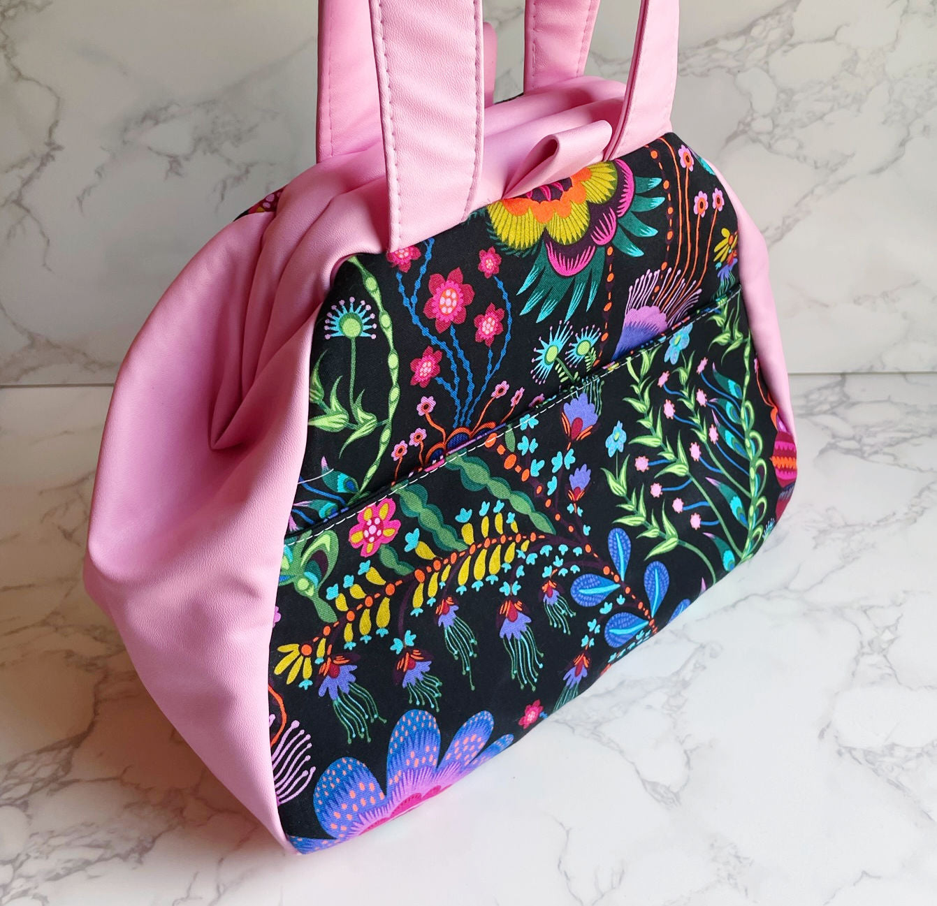 Pink purse with floral print.