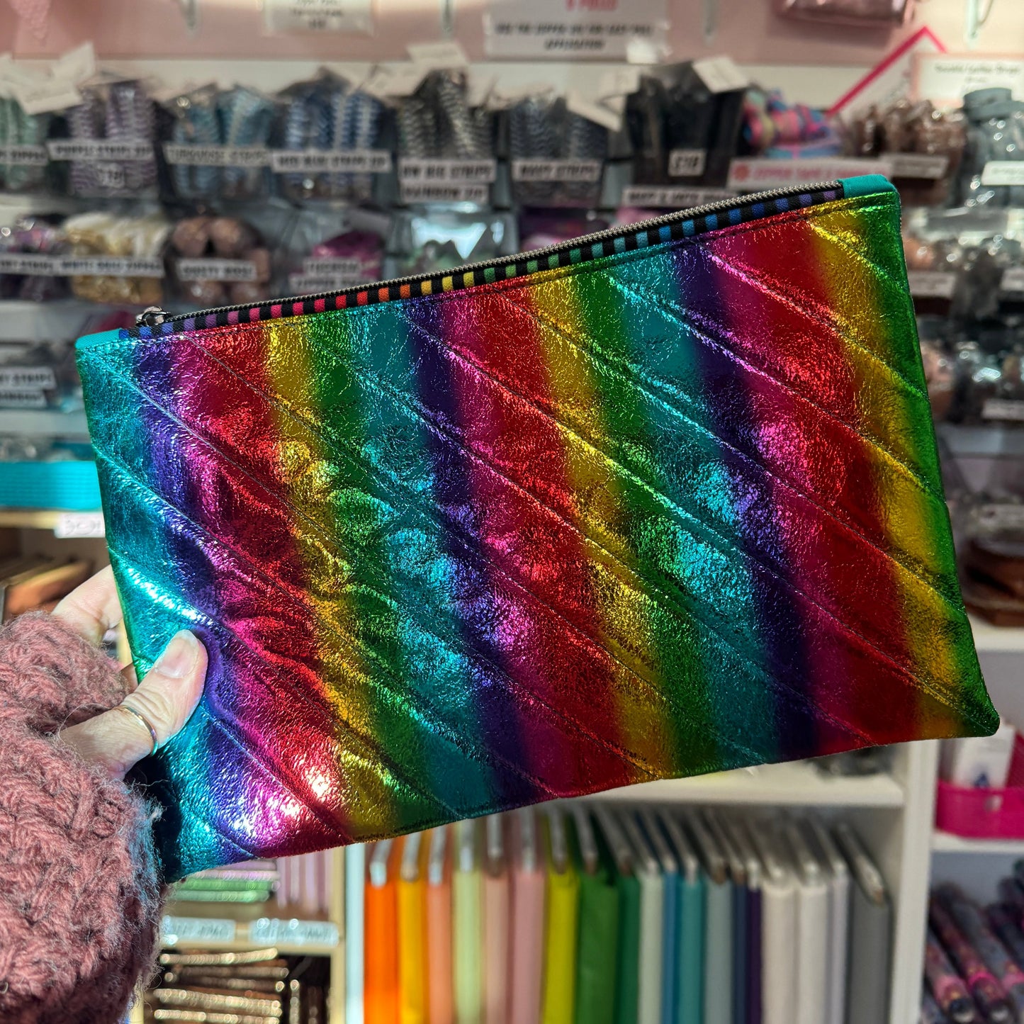 Rainbow-colored, quilted clutch.