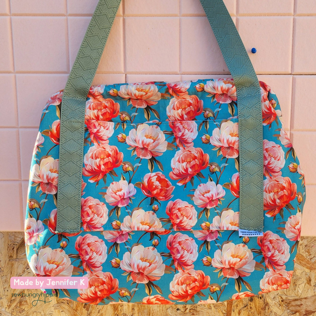 Handmade joplin in Coral Crush Peonies Canvas Fabric in blue background