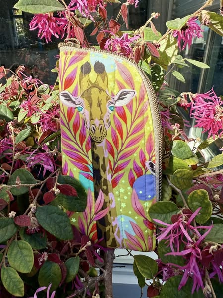 Karen F's giraffe print bag among flowers