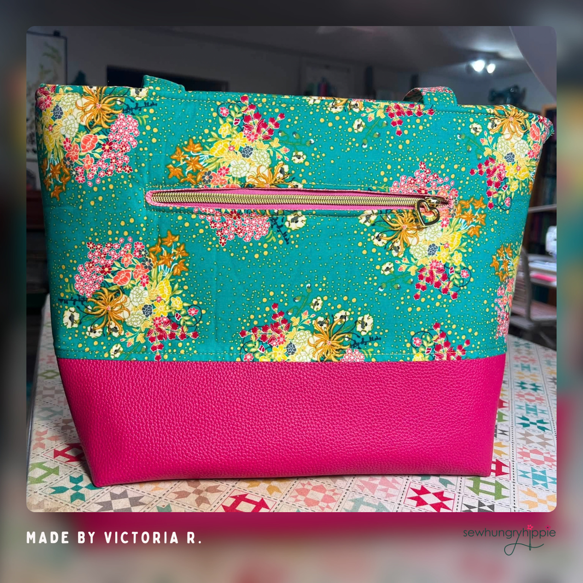 Tote in teal floral print with a lipstick pink vinyl base