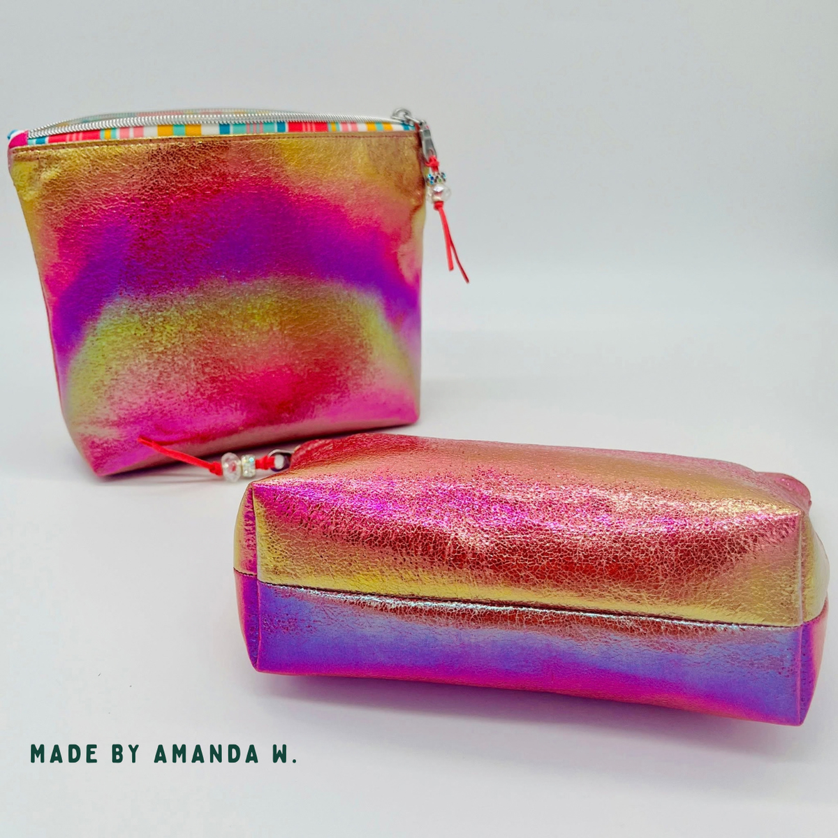 Two zipper pouches in magenta-orange shift vinyl