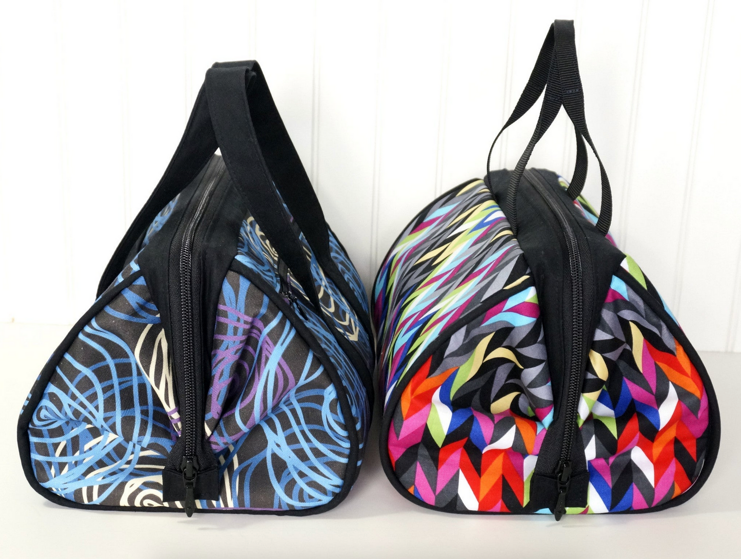 Two colorful bags with abstract patterns on a white background