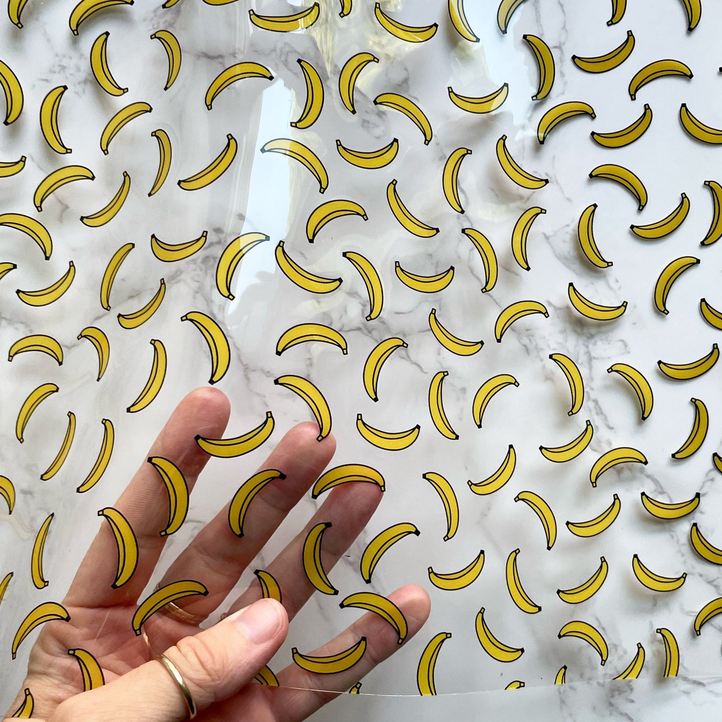 Bananavinyl sheet with banana pattern held in hand.