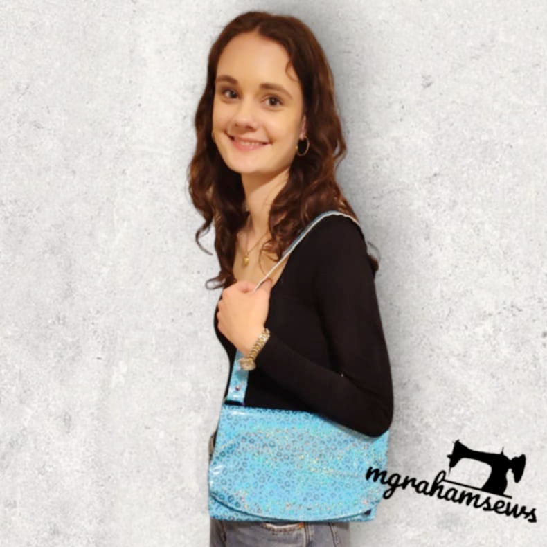 Carly carrying blue sparkly shoulder bag