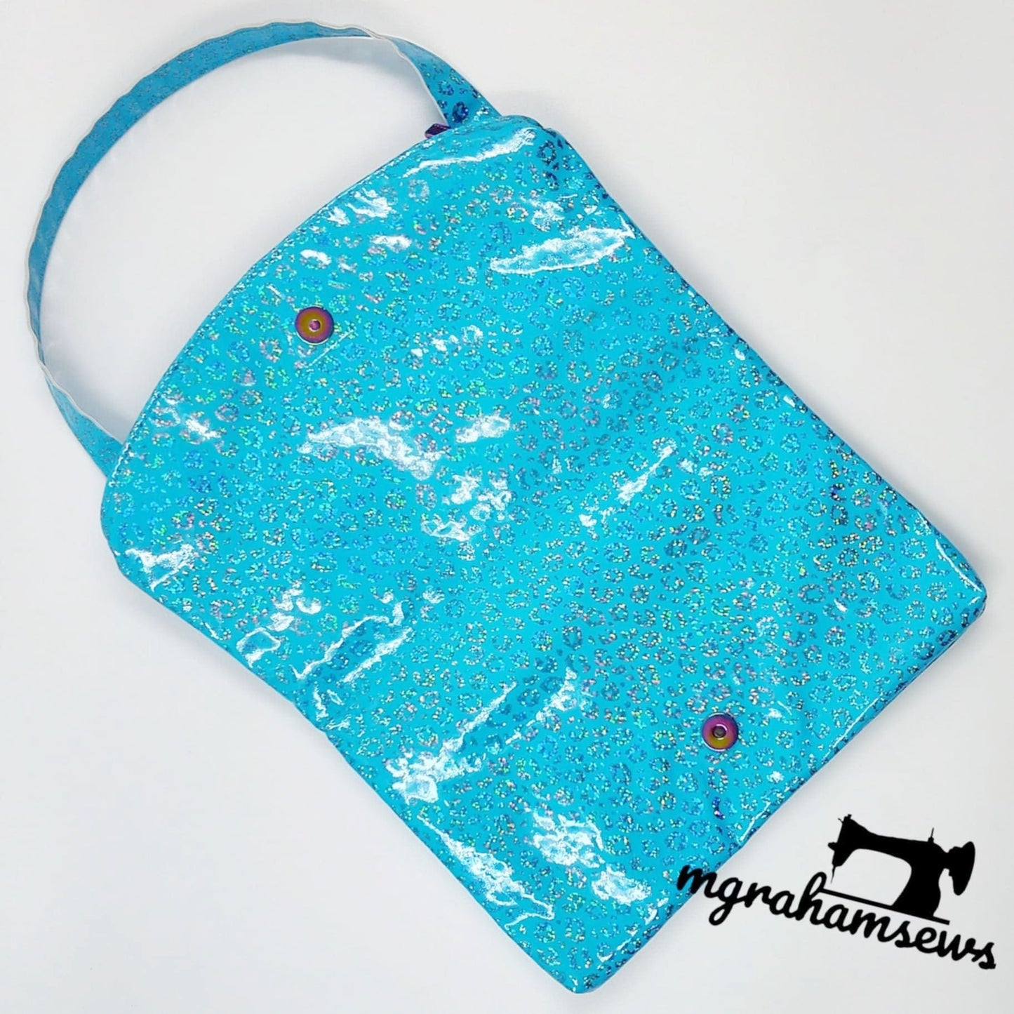 Carly clutch sewing pattern in blue glitter fabric