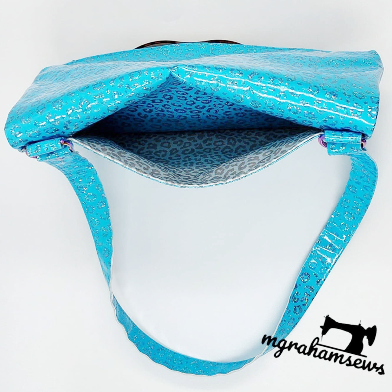 Carly pocket bag view, blue vinyl with leopard lining