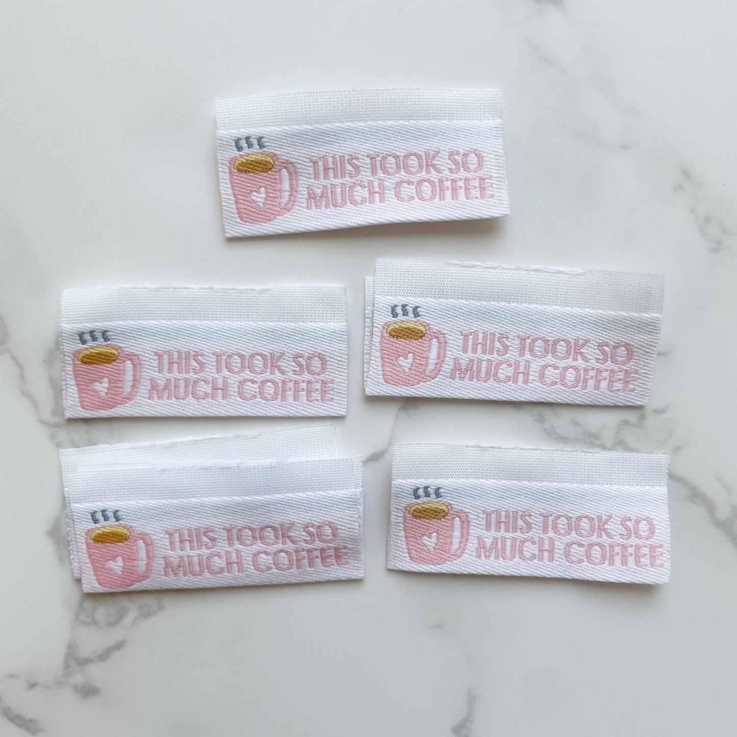 Five fabric labels with text This took so much coffee.