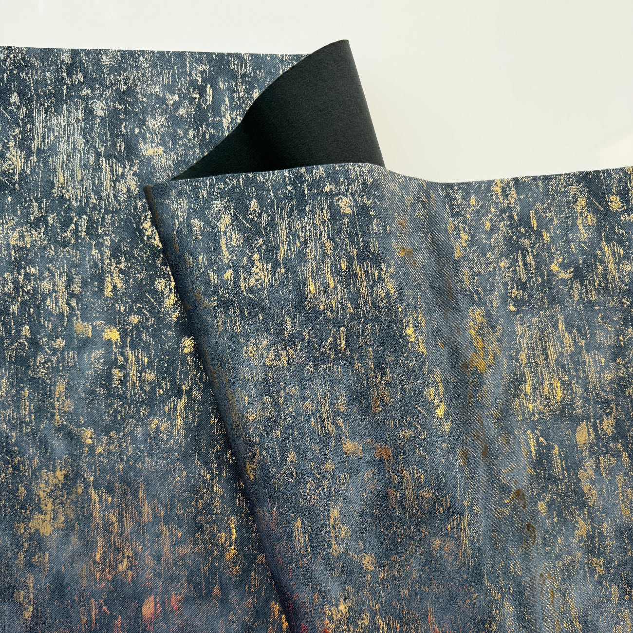 Textured blue and gold vinyl roll on a white background