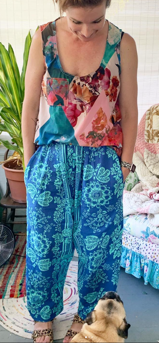 Woman in floral top & blue pants with pug, ethelpantsquiltingcotton