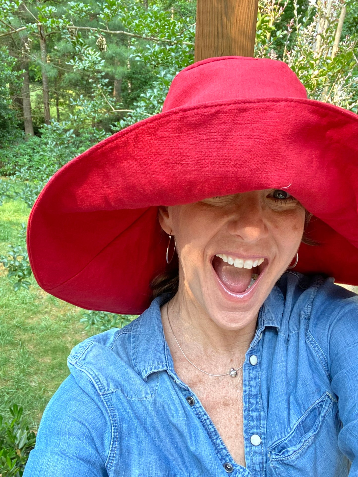 Woman in red sun hat smiling