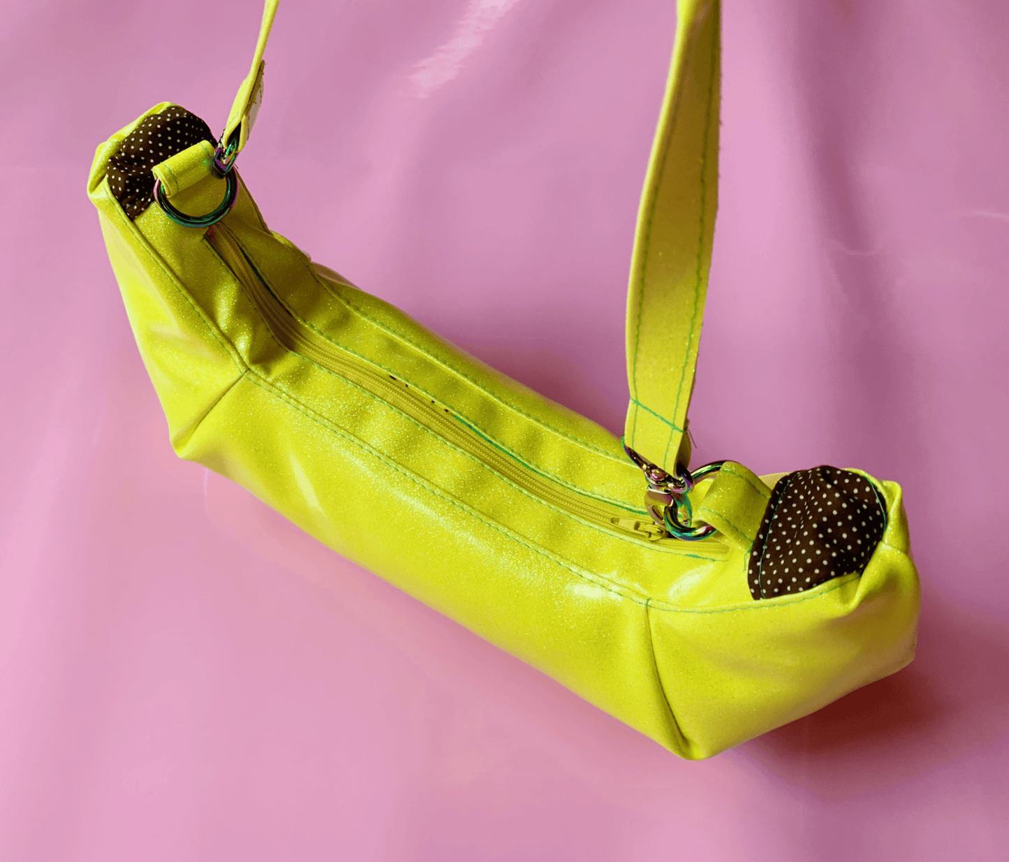 Yellow shoulder bag with brown polka dot accents.