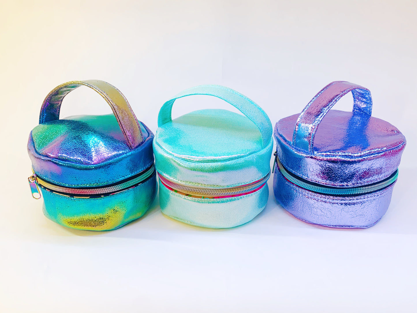 Iridescent mini handbags in teal, aqua, & purple