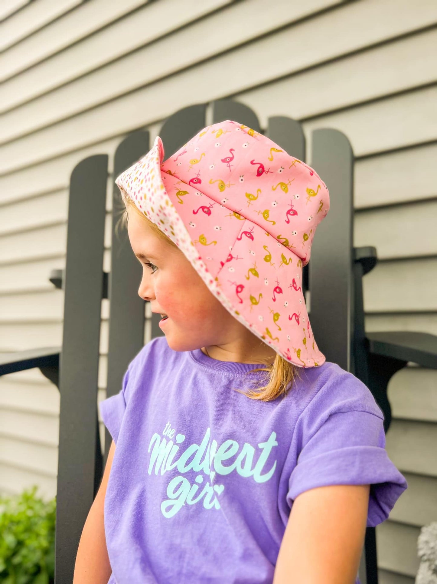 Dodi wearing pink flamingo hat