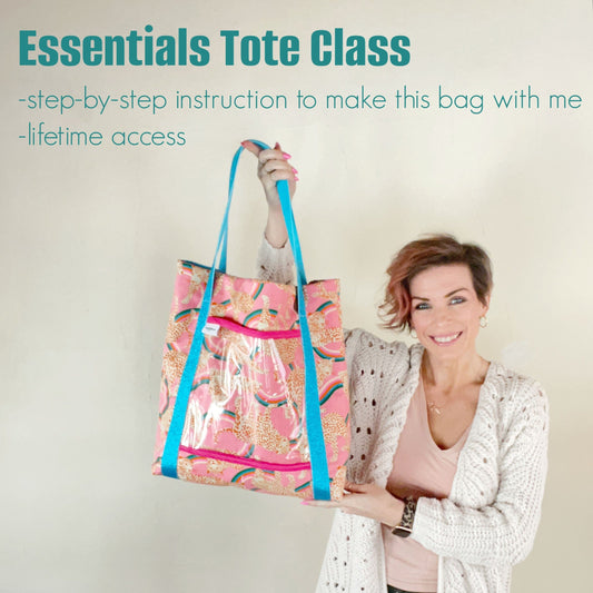 Woman holding a pink tote bag with blue straps.