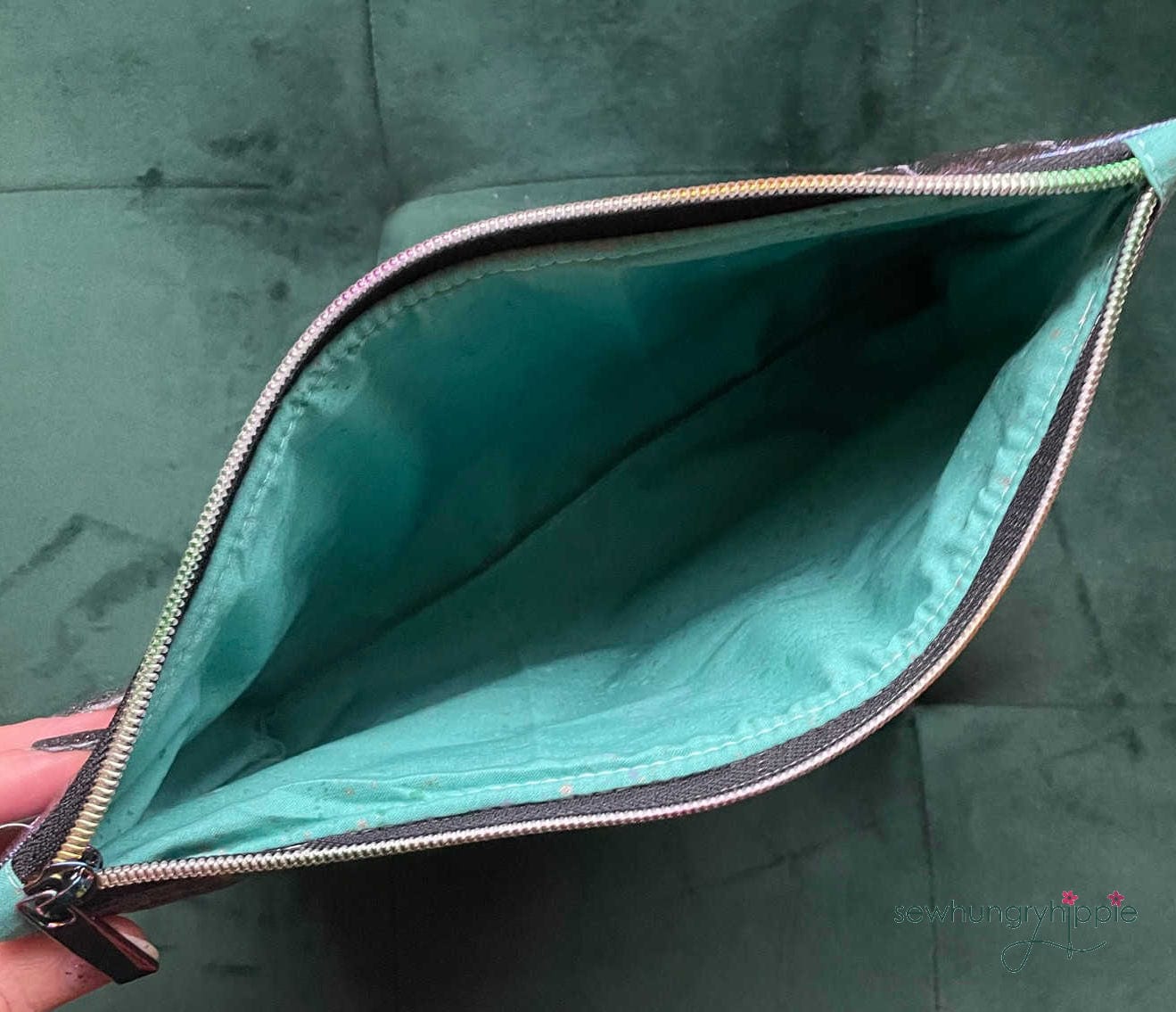 Open zippered pouch with turquoise lining.