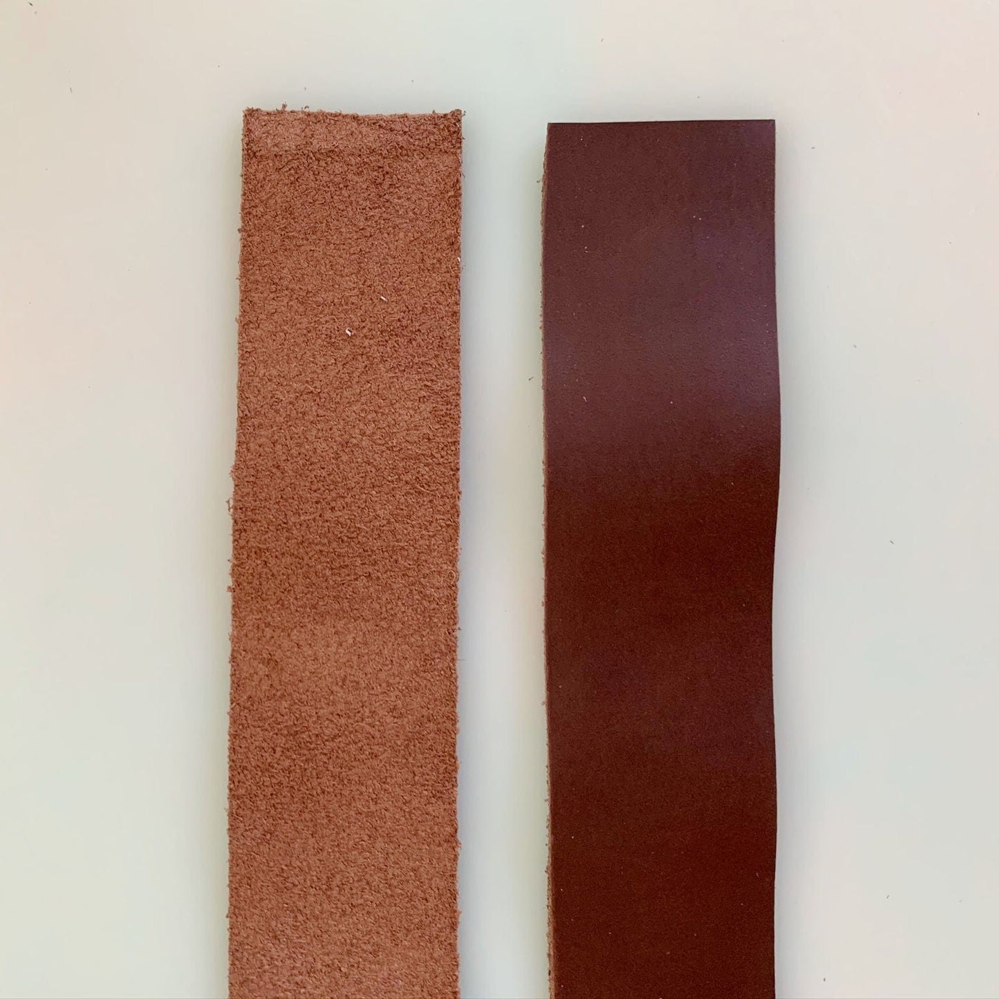Two leather strips, one rough and one smooth.