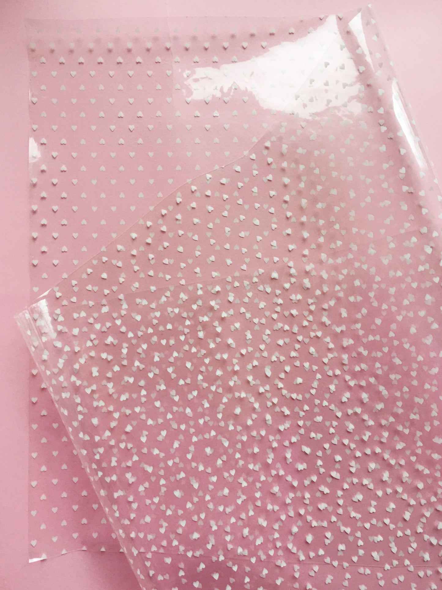 Clear plastic sheet with white polka dots.