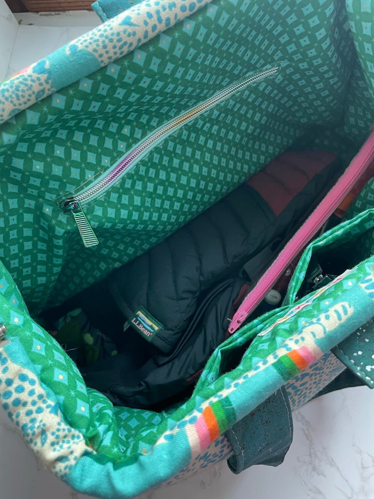 Inside green patterned tote bag with items