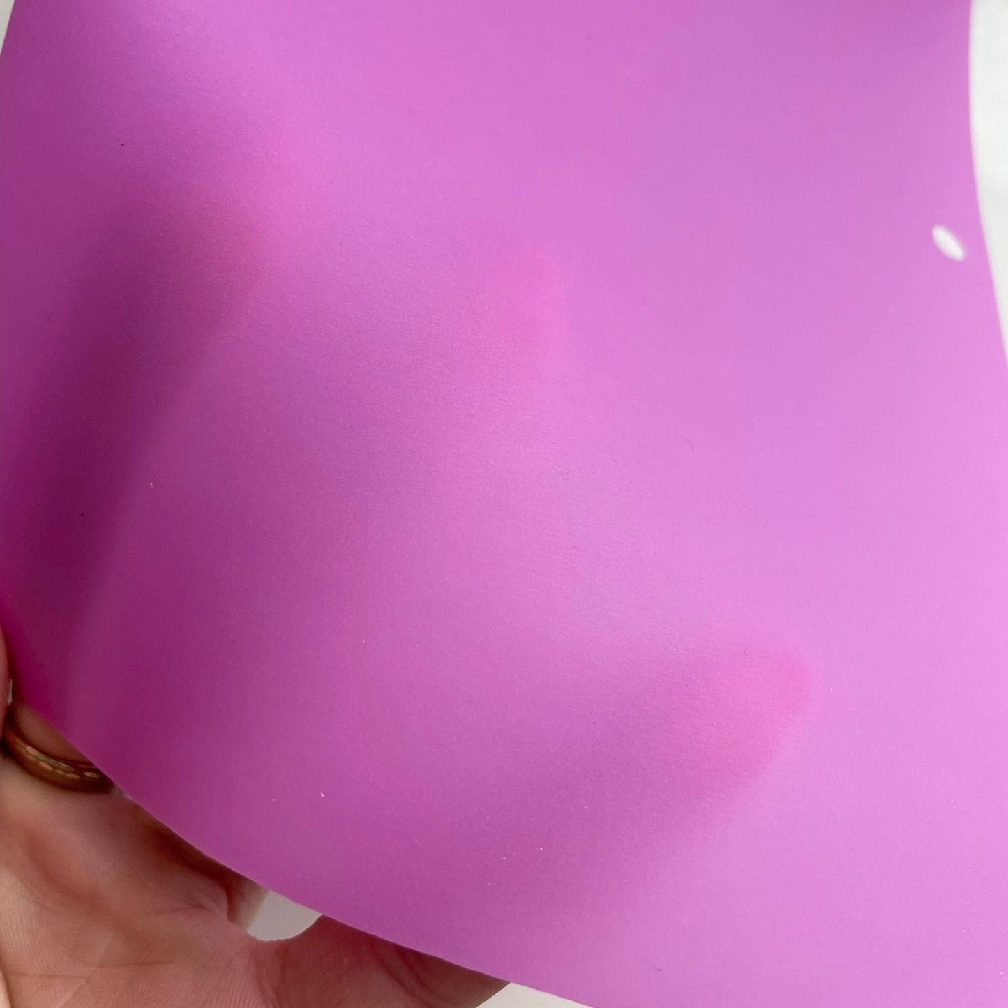 Purple fabric with a white spot.