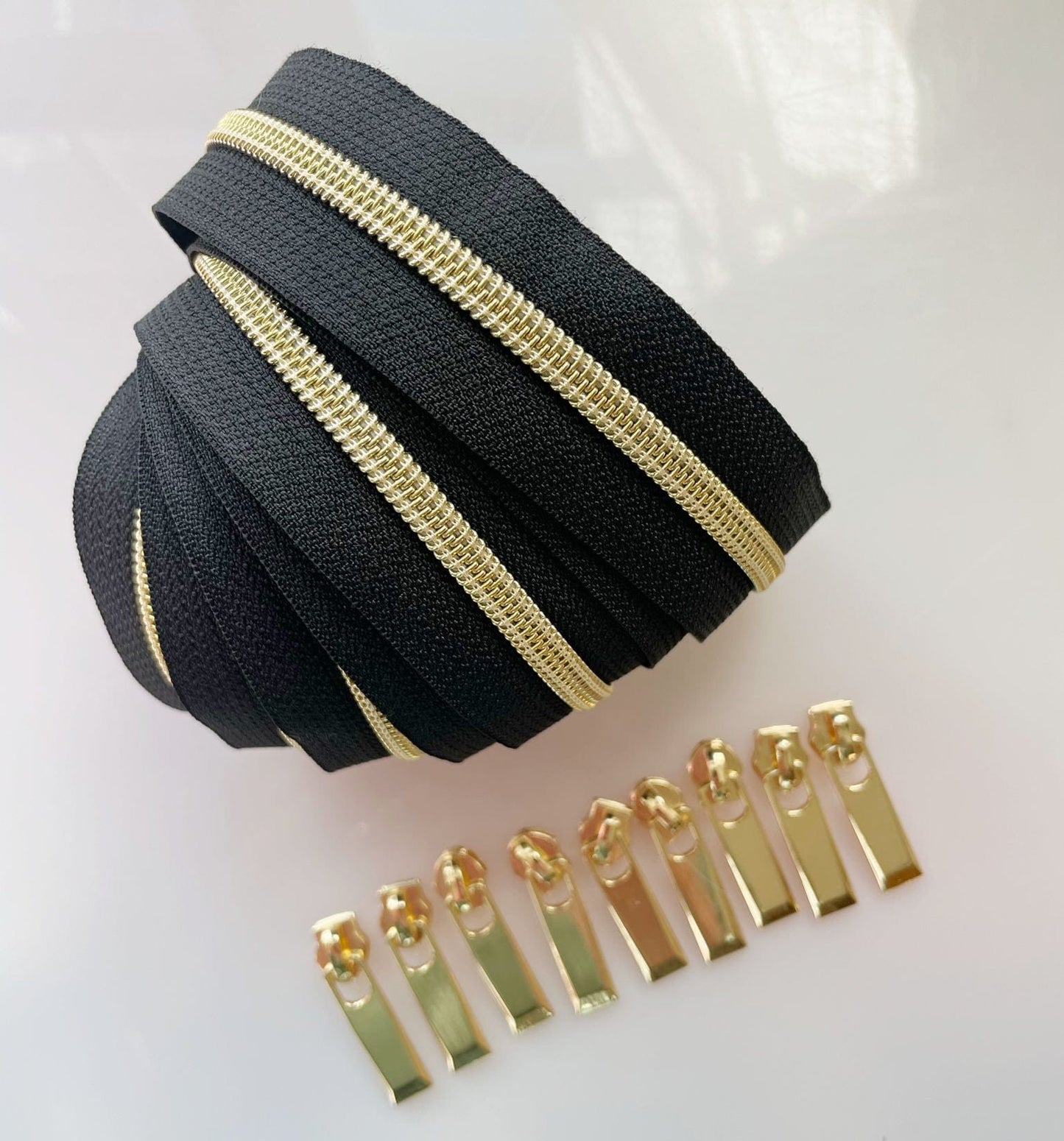 Black and gold zipper tape and zipper pulls.