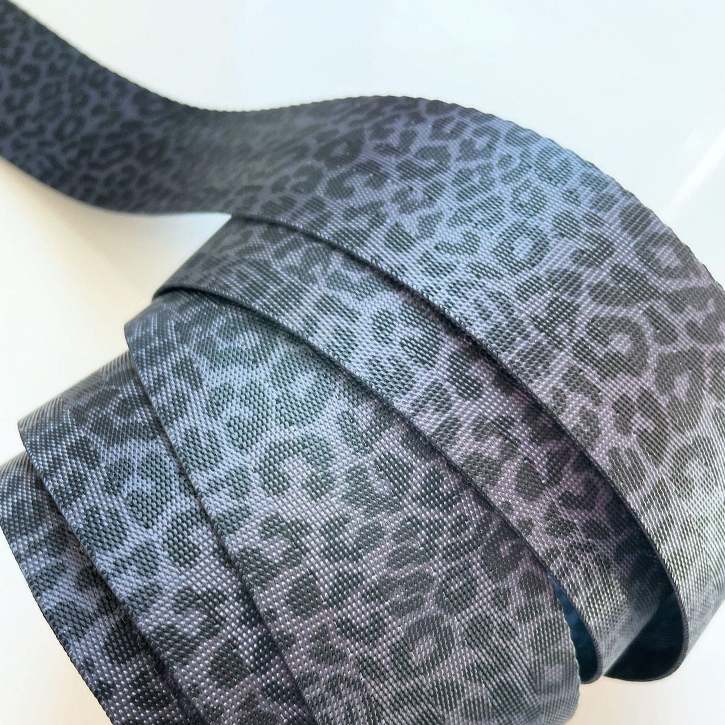 Rolled gray leopard print ribbon.