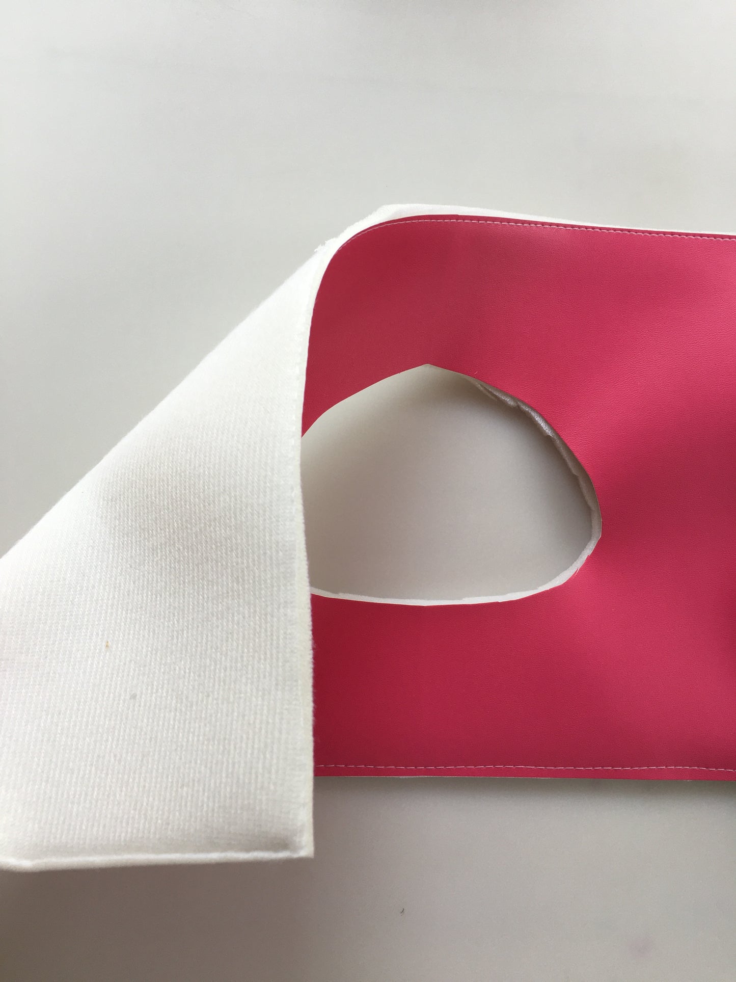 Pink and white mask with eyehole.
