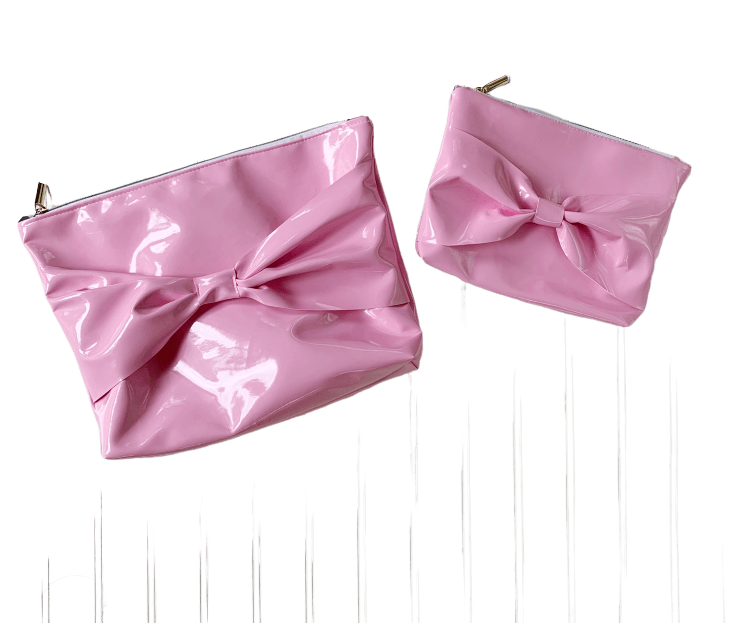 Two pink clutch bags with big bows