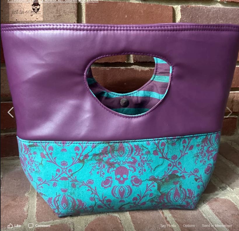 Purple handbag with teal floral design