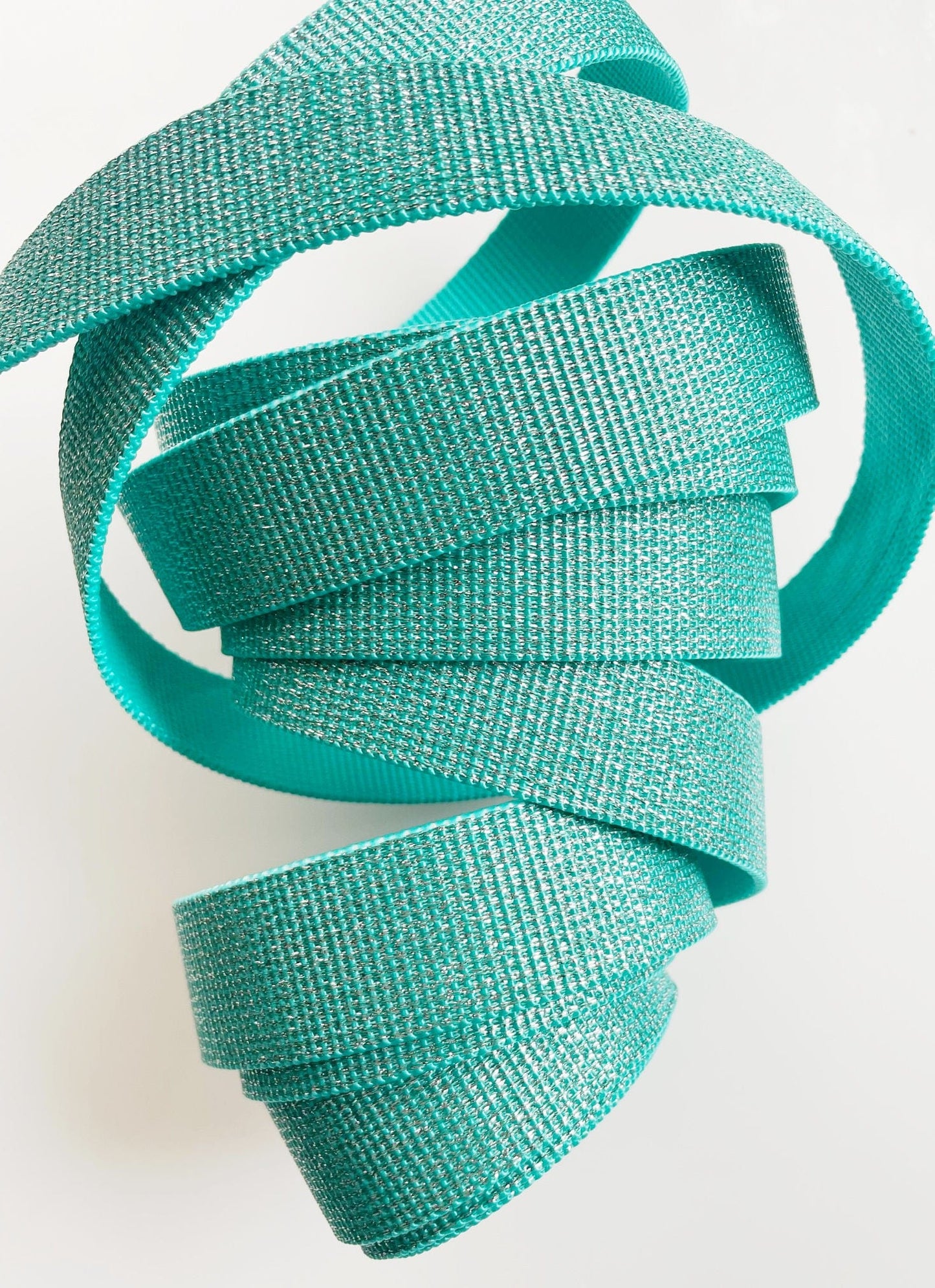 Aquamarine strap coiled on white background