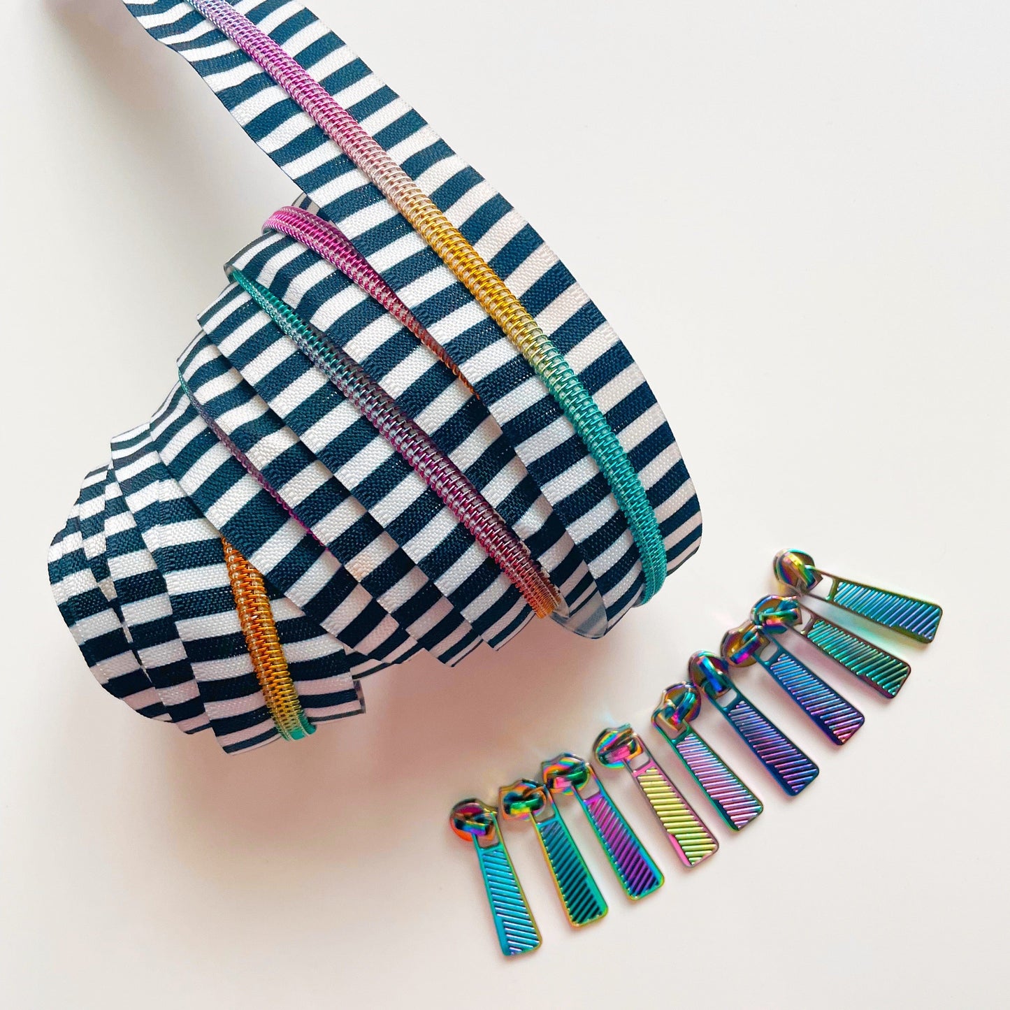 Black and white striped zipper with rainbow teeth and pulls.