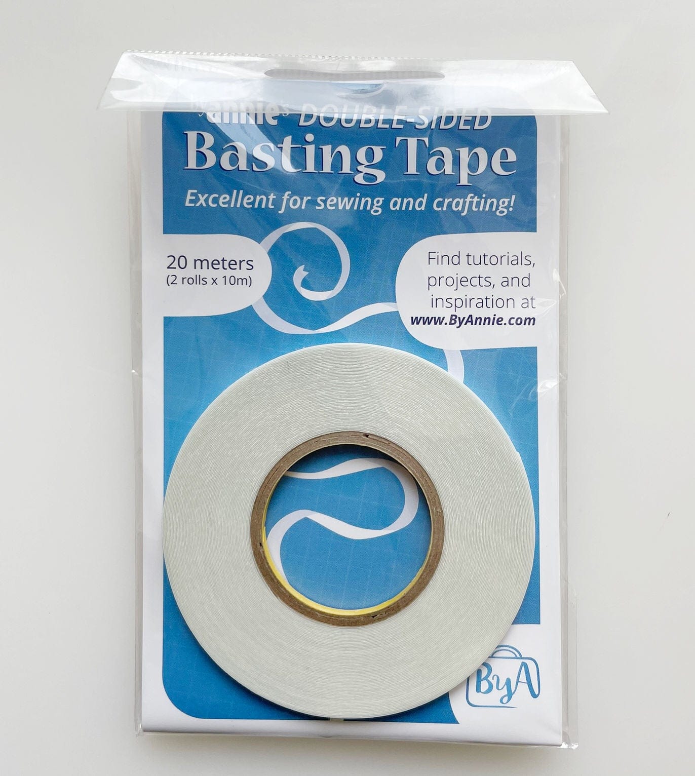 Double-sided basting tape roll for sewing and crafting.
