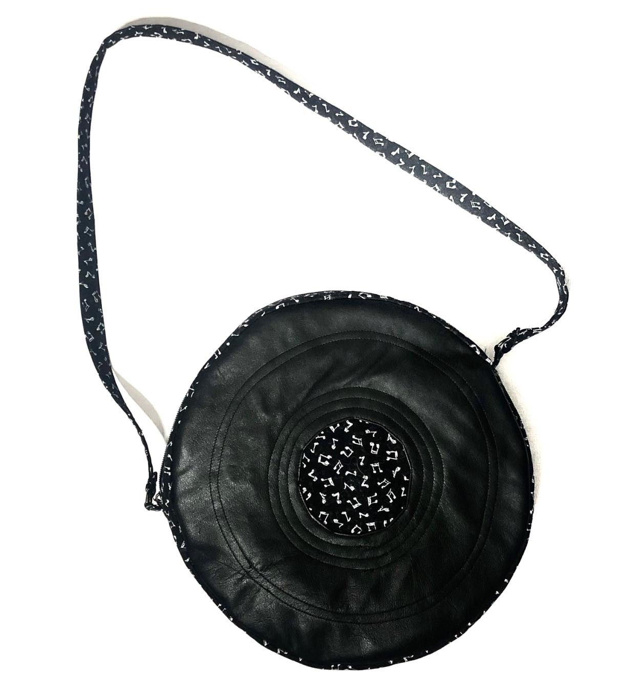 Erin's black round purse with music note center detail
