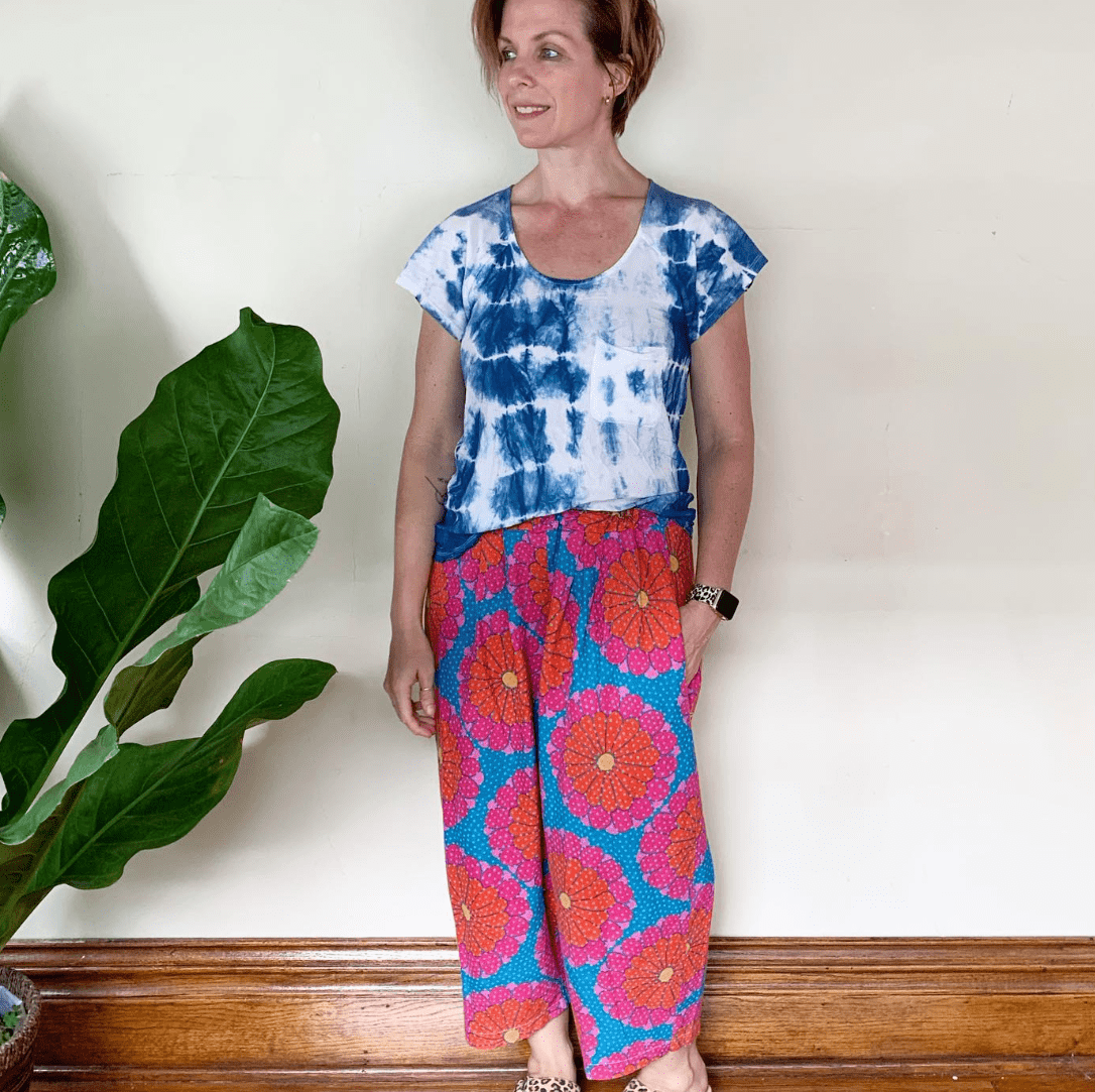 Woman in tie-dye top and patterned pants, ethelpant style.